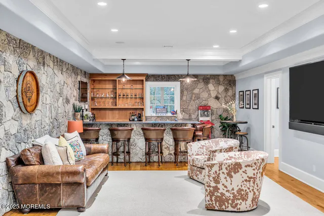 a living room with furniture a flat screen tv and a large window