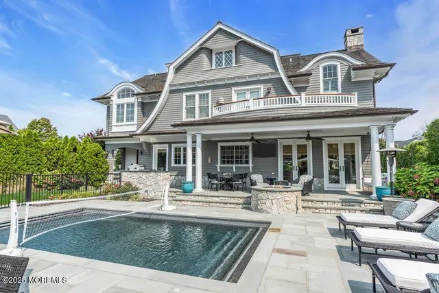 a view of a patio with a table and chairs under an umbrella