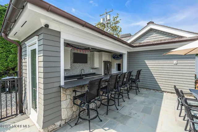 a view of a house with swimming pool and sitting area