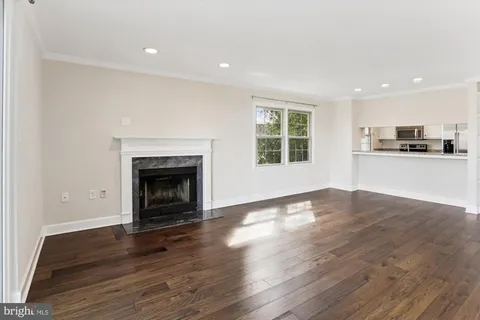 a view of a room with wooden floor and a fireplace