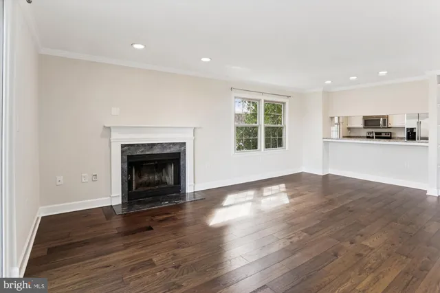 a view of a room with wooden floor and a fireplace
