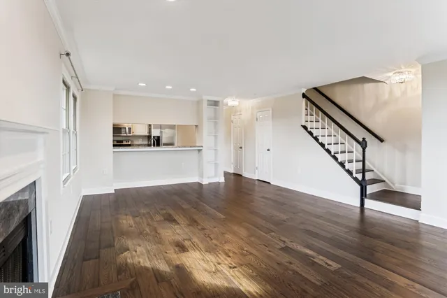 a view of a kitchen with wooden floor and electronic appliances