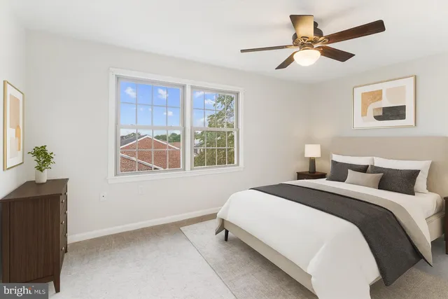 a bedroom with a bed a window and a chandelier