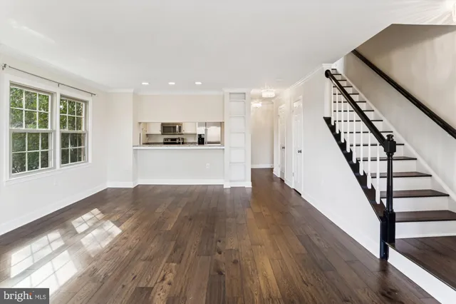 a view of a kitchen with wooden floor and electronic appliances