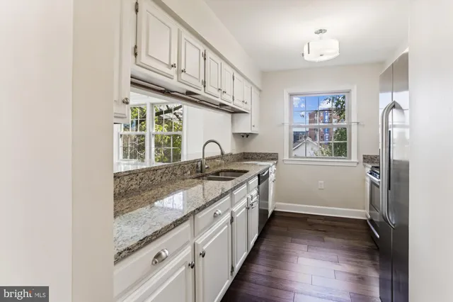 a kitchen with stainless steel appliances granite countertop a stove and a sink