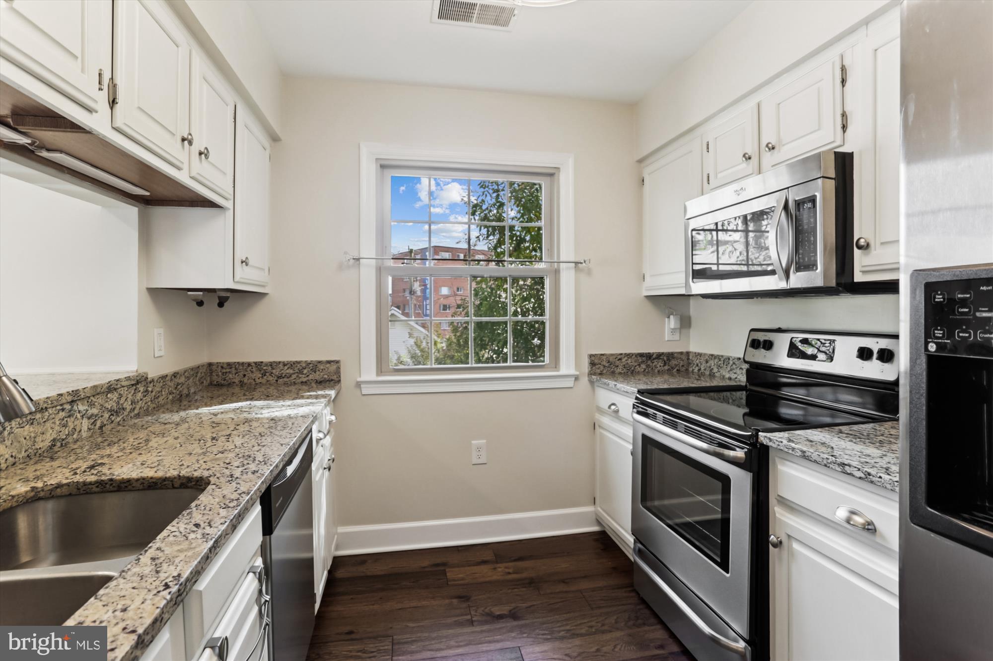 945 South Scott Street Arlington, VA 22204 - Photo 8 of 39 a kitchen with granite countertop cabinets stainless steel appliances and wooden floor