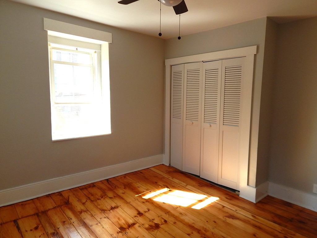 128 Allen Street Athol, MA 01331 - Photo 22 of 27 a view of an empty room with window and wooden floor