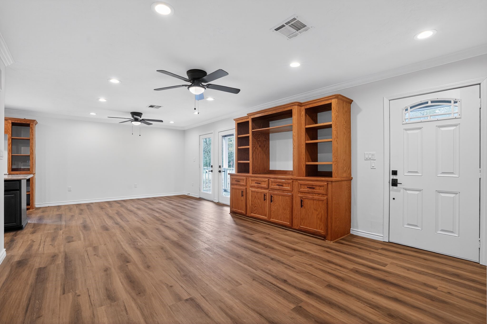 27 Deerfield Road Huntsville, TX 77340 - Photo 17 of 46 wooden floor in an empty room with a window