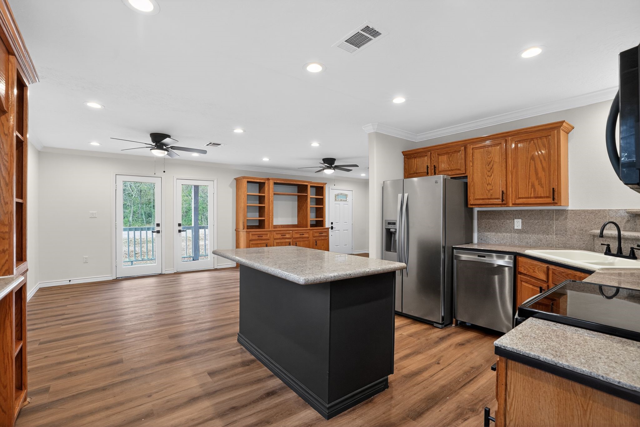 27 Deerfield Road Huntsville, TX 77340 - Photo 20 of 46 a kitchen with stainless steel appliances granite countertop a refrigerator a sink dishwasher a stove and a oven with wooden floor