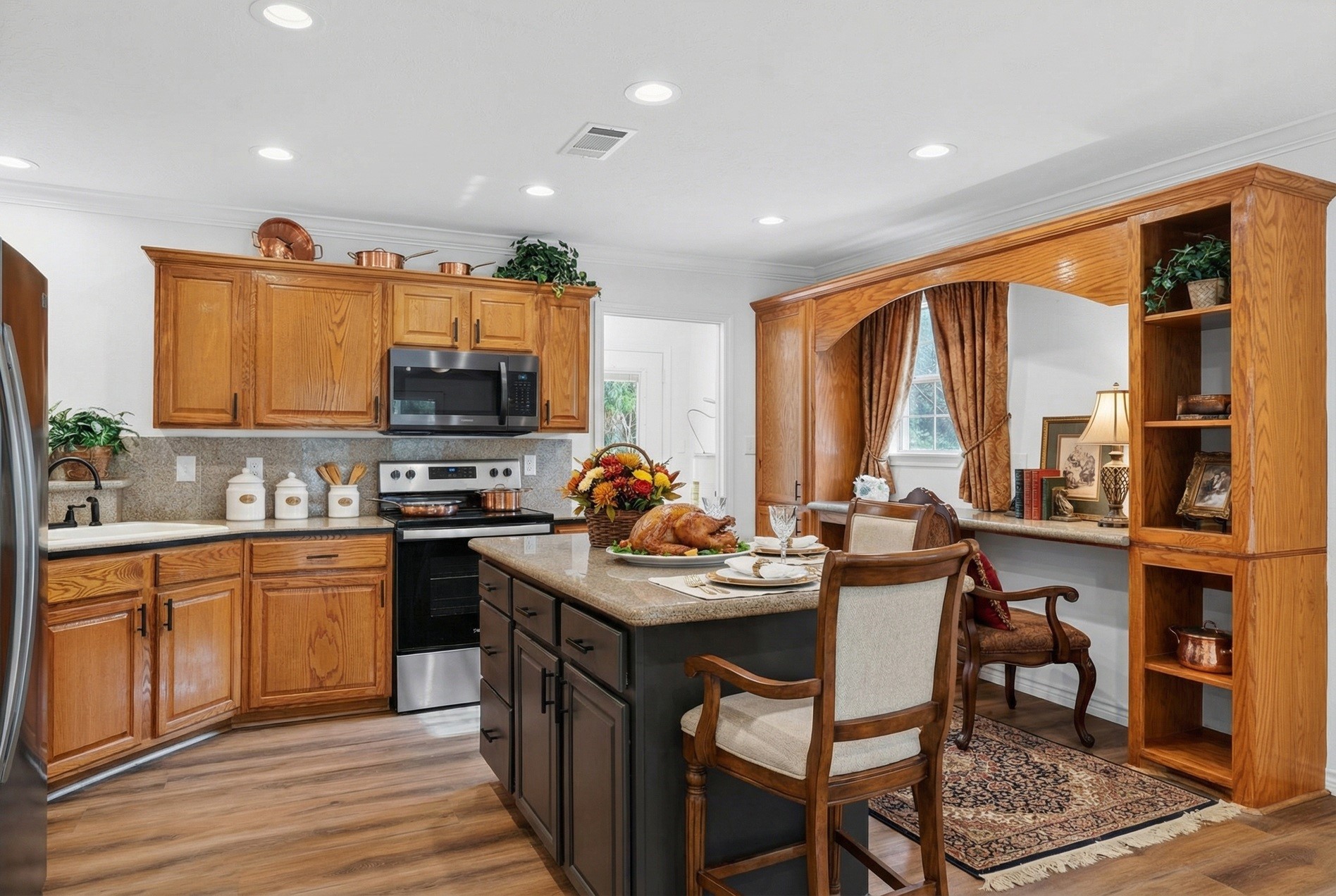 27 Deerfield Road Huntsville, TX 77340 - Photo 4 of 46 a kitchen with stainless steel appliances granite countertop a stove top oven a sink dishwasher a dining table and chairs with wooden floor