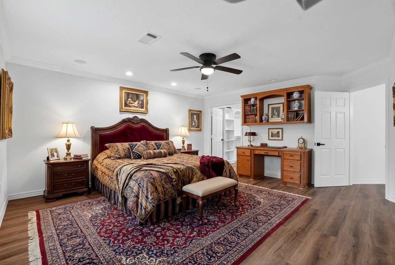 27 Deerfield Road Huntsville, TX 77340 - Photo 6 of 46 a spacious bedroom with a bed and wooden floor