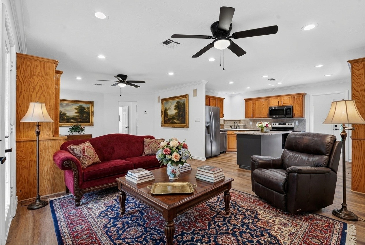 27 Deerfield Road Huntsville, TX 77340 - Photo 8 of 46 a living room with furniture kitchen view and a fireplace