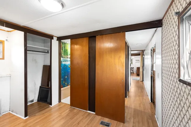a view of a hallway with wooden floor
