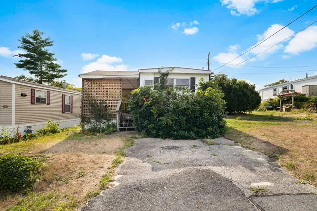 a backyard of a house with table and chairs
