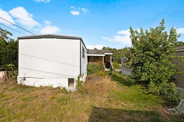 a view of a house with a yard and deck