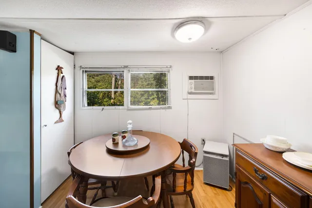 a view of a dining room with furniture and window