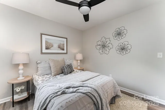 a bedroom with a bed and a painting on the wall