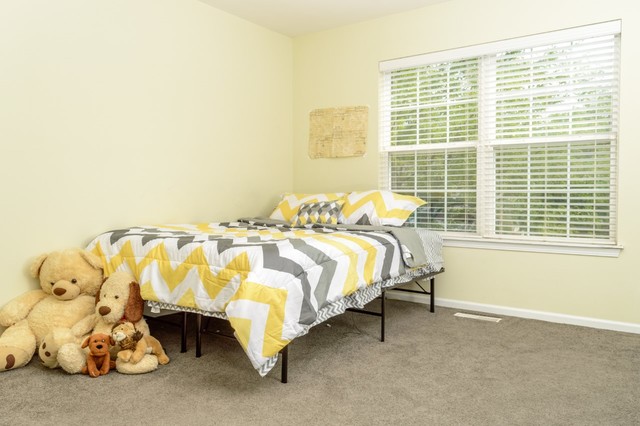 229 Ridge Road North Aurora, IL 60542 - Photo 16 of 18 a bed sitting in a bedroom next to a window