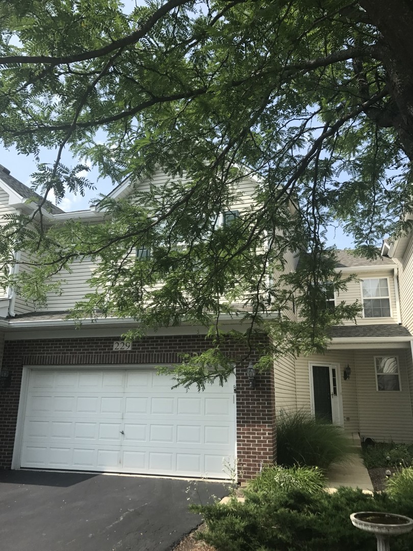 229 Ridge Road North Aurora, IL 60542 - Photo 2 of 18 a view of a yard in front of a house with large tree