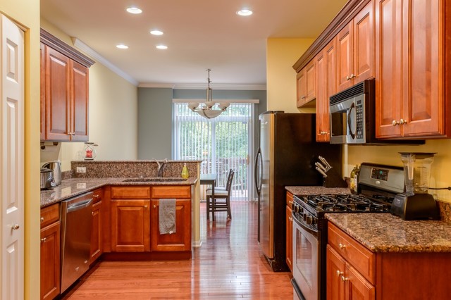 229 Ridge Road North Aurora, IL 60542 - Photo 4 of 18 a kitchen with stainless steel appliances granite countertop a refrigerator a stove top oven and sink