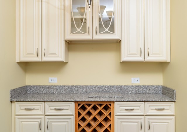 229 Ridge Road North Aurora, IL 60542 - Photo 5 of 18 a kitchen with granite countertop a sink and a white cabinets