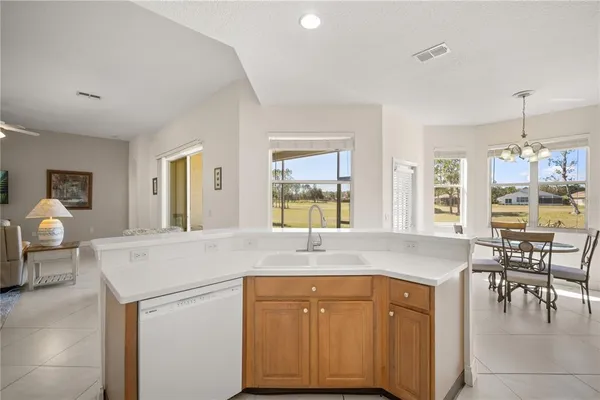 a view with granite countertop kitchen island a sink table and chairs
