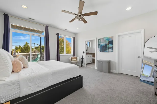 a bedroom with a bed couch and a window