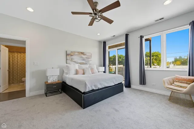 a living room with a bed furniture and a large window