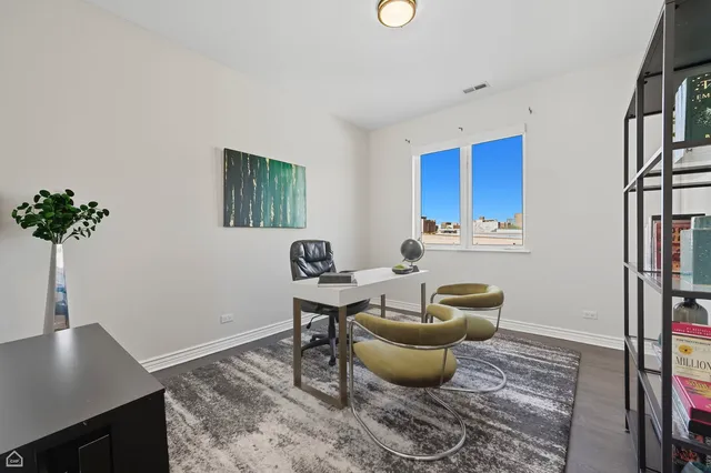 a living room with furniture a piano and a potted plant