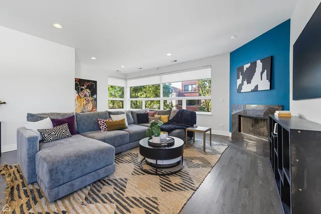 a living room with furniture a window and a flat screen tv