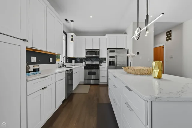 a kitchen with cabinets a sink and white appliances