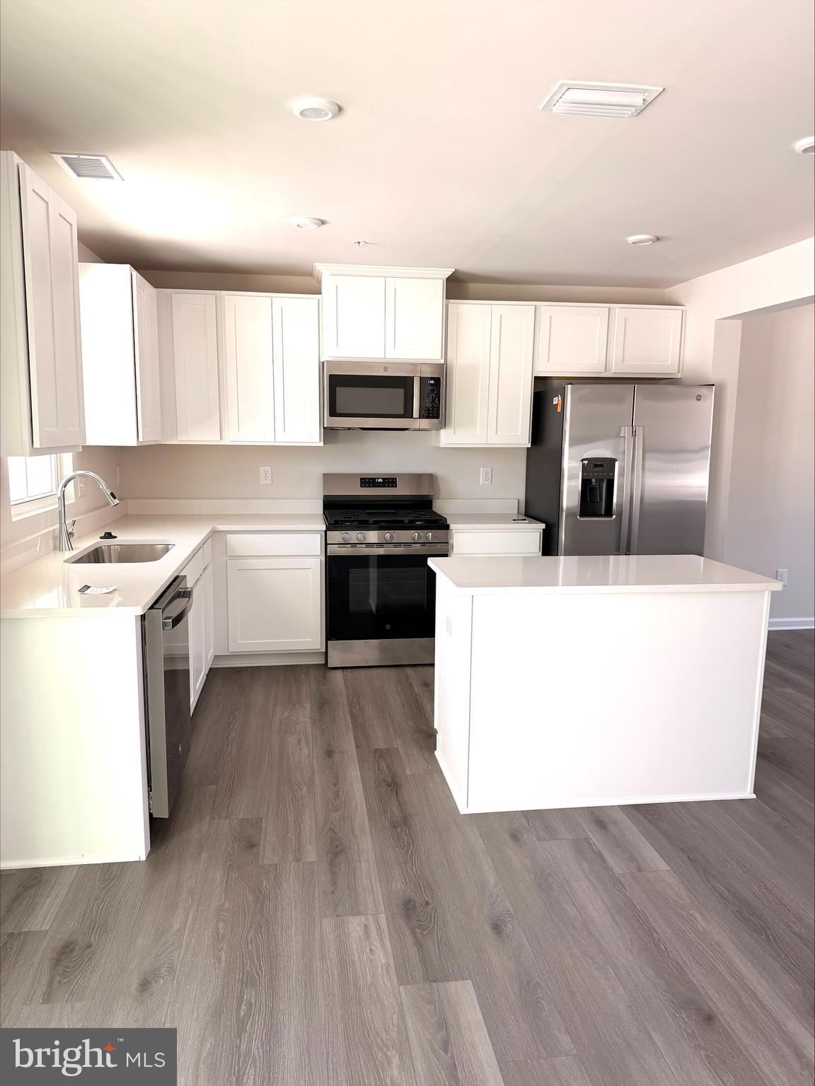 1180 West Walnut Road Vineland, NJ 08360 - Photo 2 of 19 a kitchen with stainless steel appliances a refrigerator a stove a sink and white cabinets