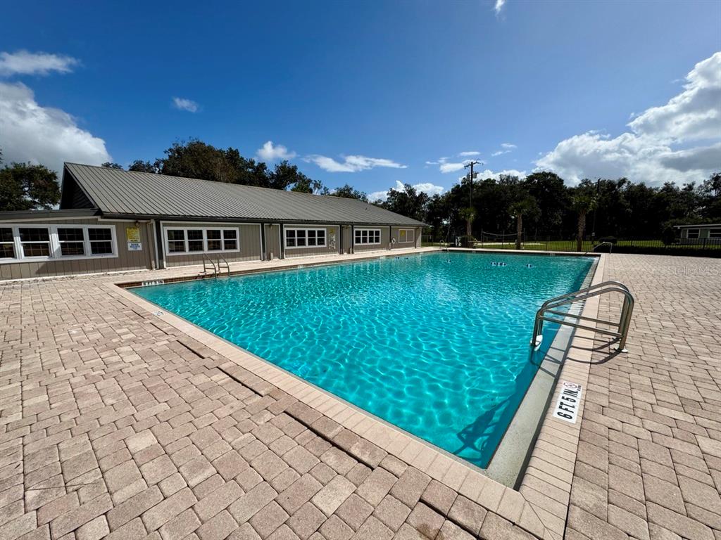 15991 Northeast 243rd Place Road, Unit 56 Fort McCoy, FL 32134 - Photo 8 of 16 a view of swimming pool with lounge chair