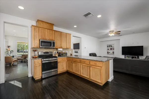 a kitchen with stainless steel appliances a stove a sink and a microwave