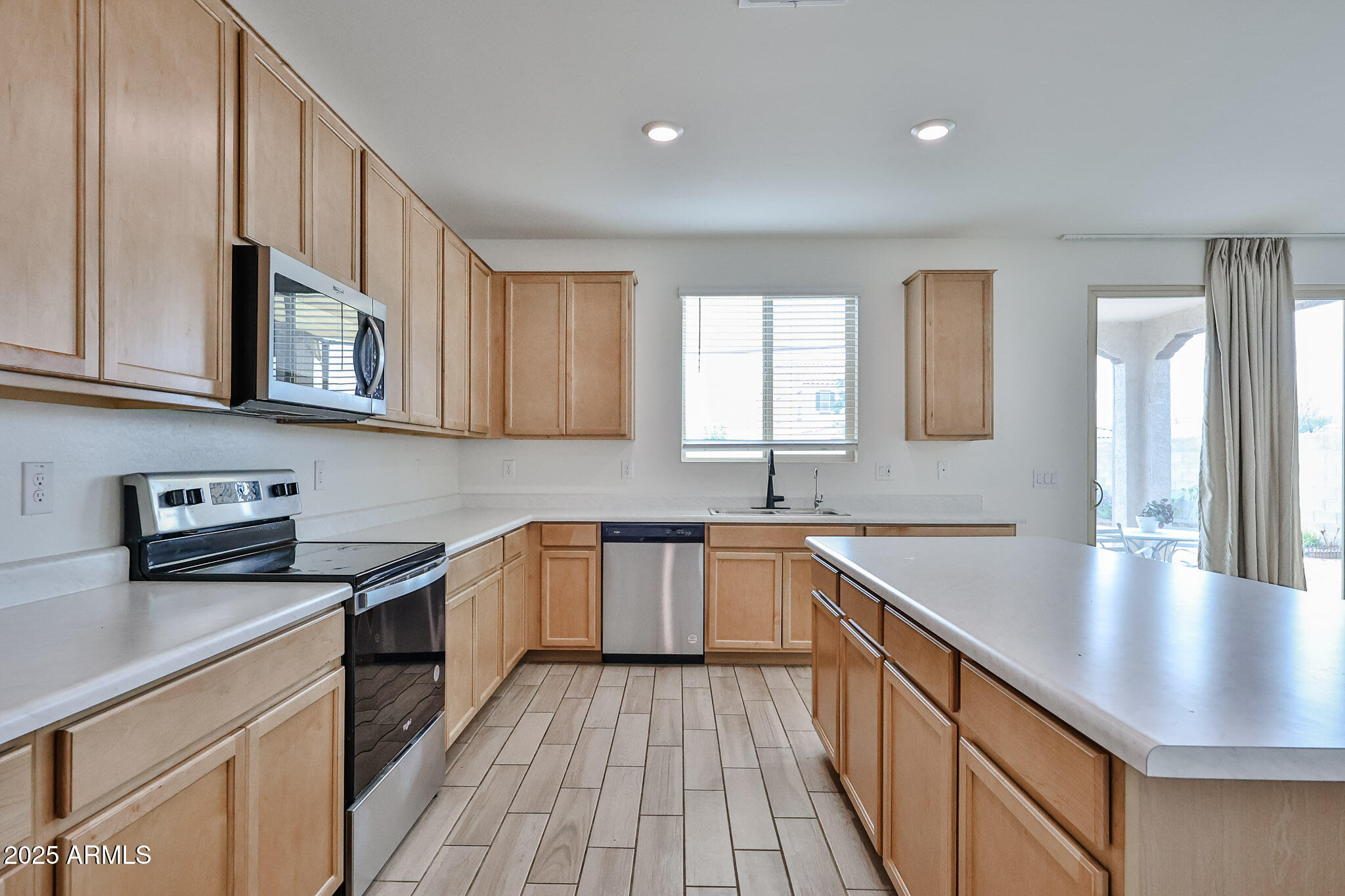 509 East Elm Lane Avondale, AZ 85323 - Photo 13 of 40 a kitchen with stainless steel appliances granite countertop a sink stove and cabinets