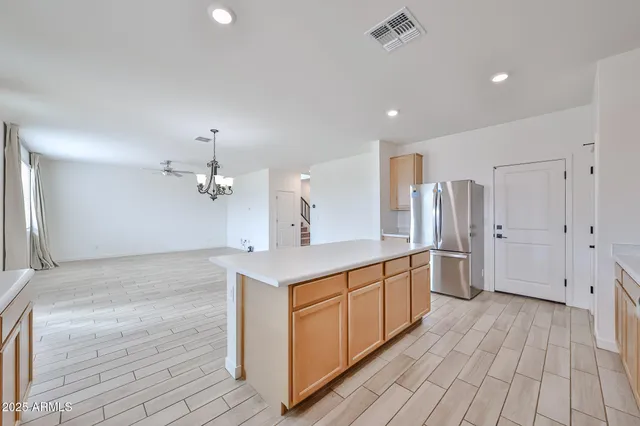 a kitchen with stainless steel appliances a sink cabinets and wooden floor