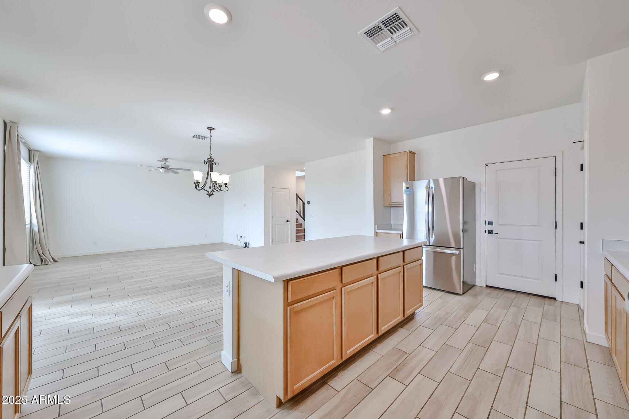 509 East Elm Lane Avondale, AZ 85323 - Photo 14 of 40 a kitchen with stainless steel appliances a sink cabinets and wooden floor