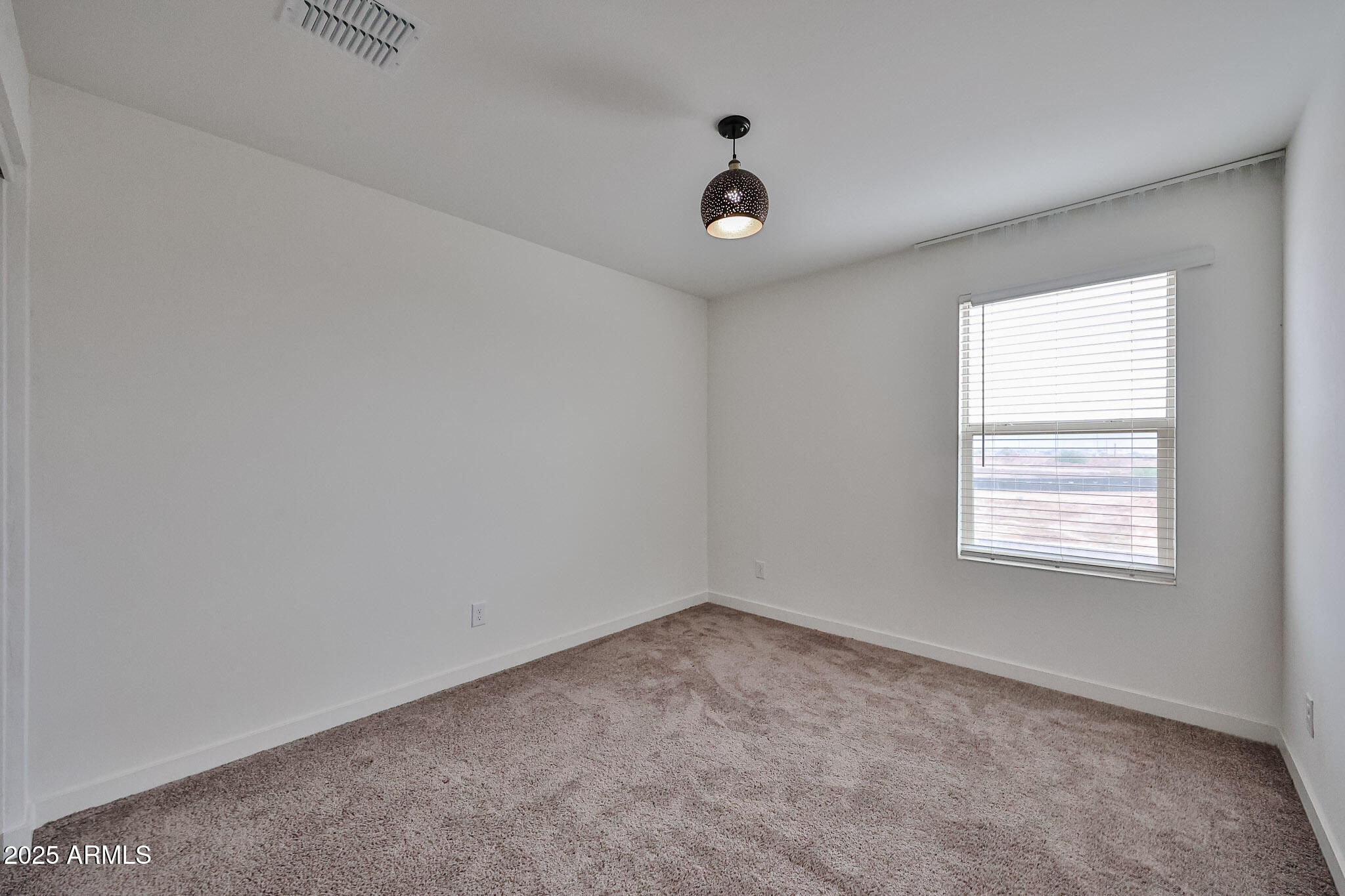 509 East Elm Lane Avondale, AZ 85323 - Photo 15 of 40 an empty room with a window