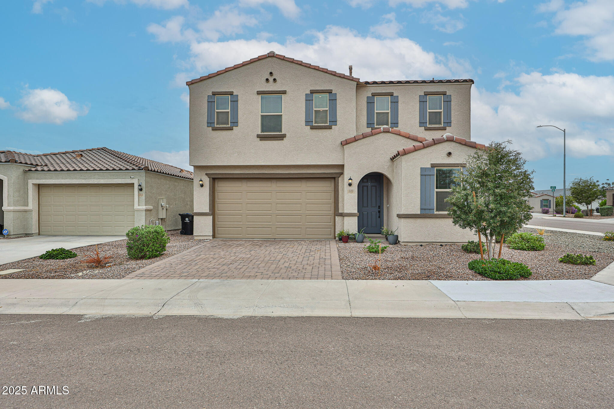 509 East Elm Lane Avondale, AZ 85323 - Photo 2 of 40 a front view of a house with a yard and garage