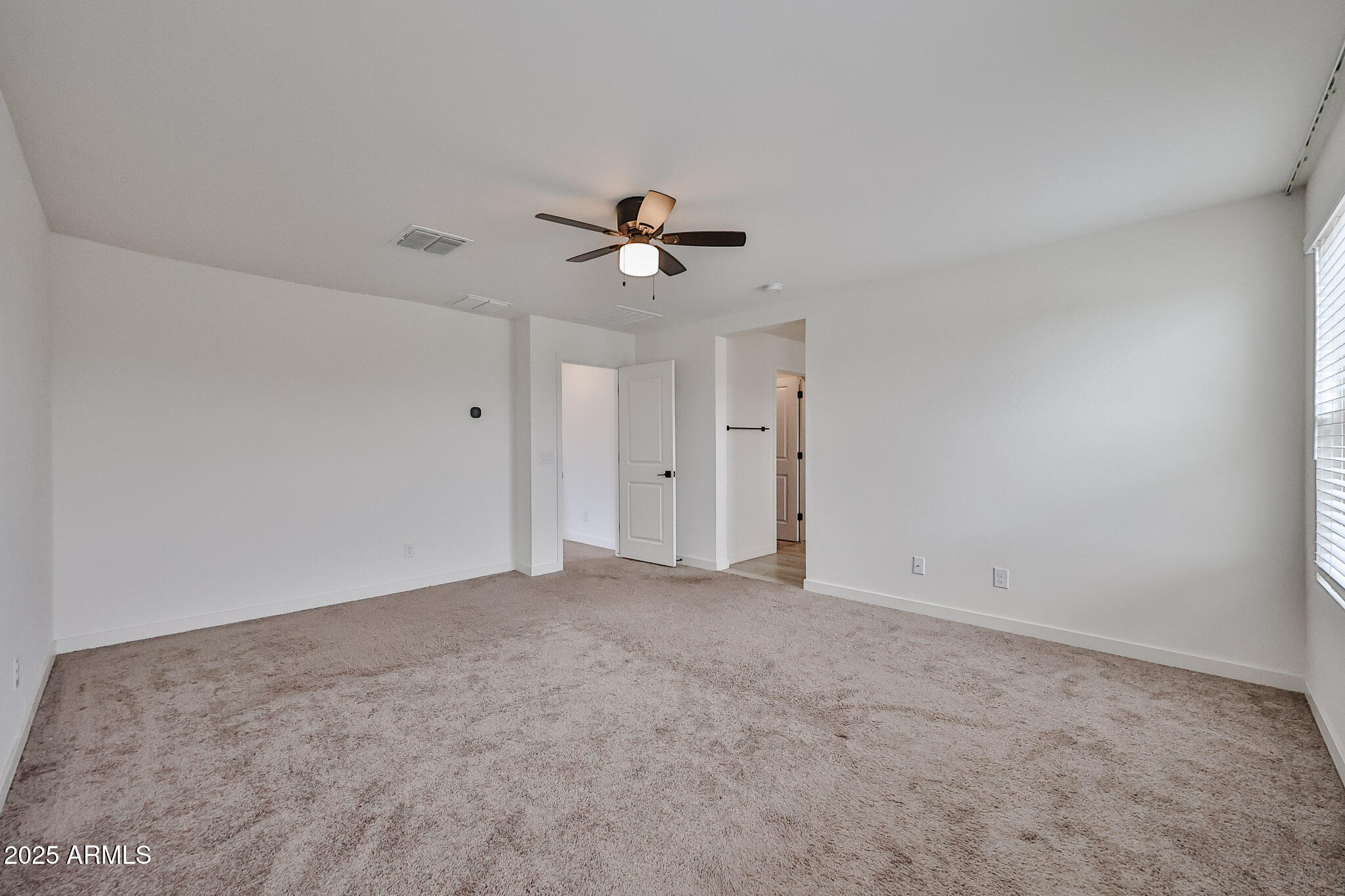 509 East Elm Lane Avondale, AZ 85323 - Photo 24 of 40 a view of an empty room with a ceiling fan