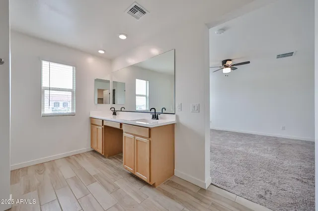 a bathroom with a sink a mirror and a bathtub