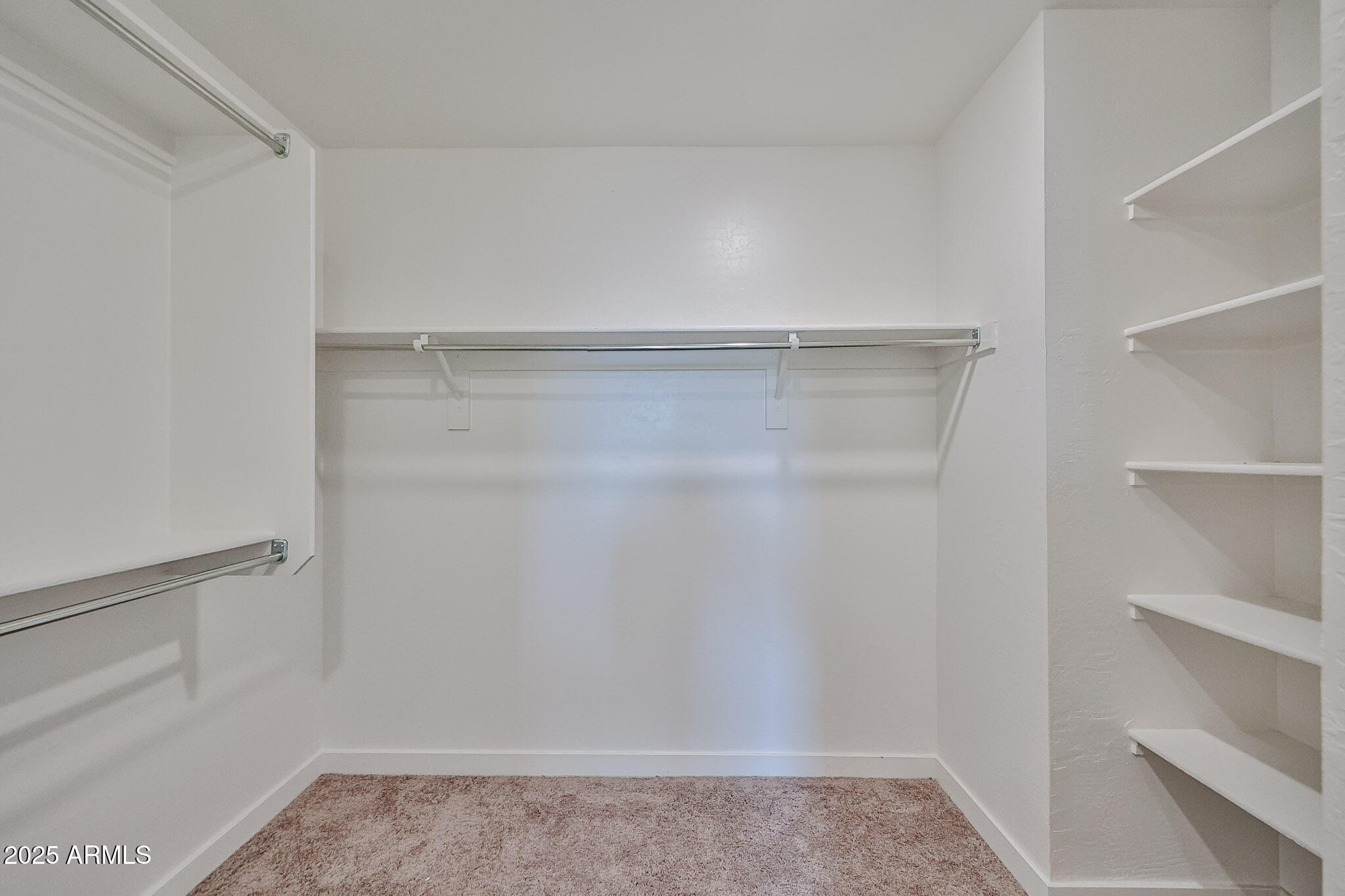 509 East Elm Lane Avondale, AZ 85323 - Photo 28 of 40 a view of walk in closet with empty racks