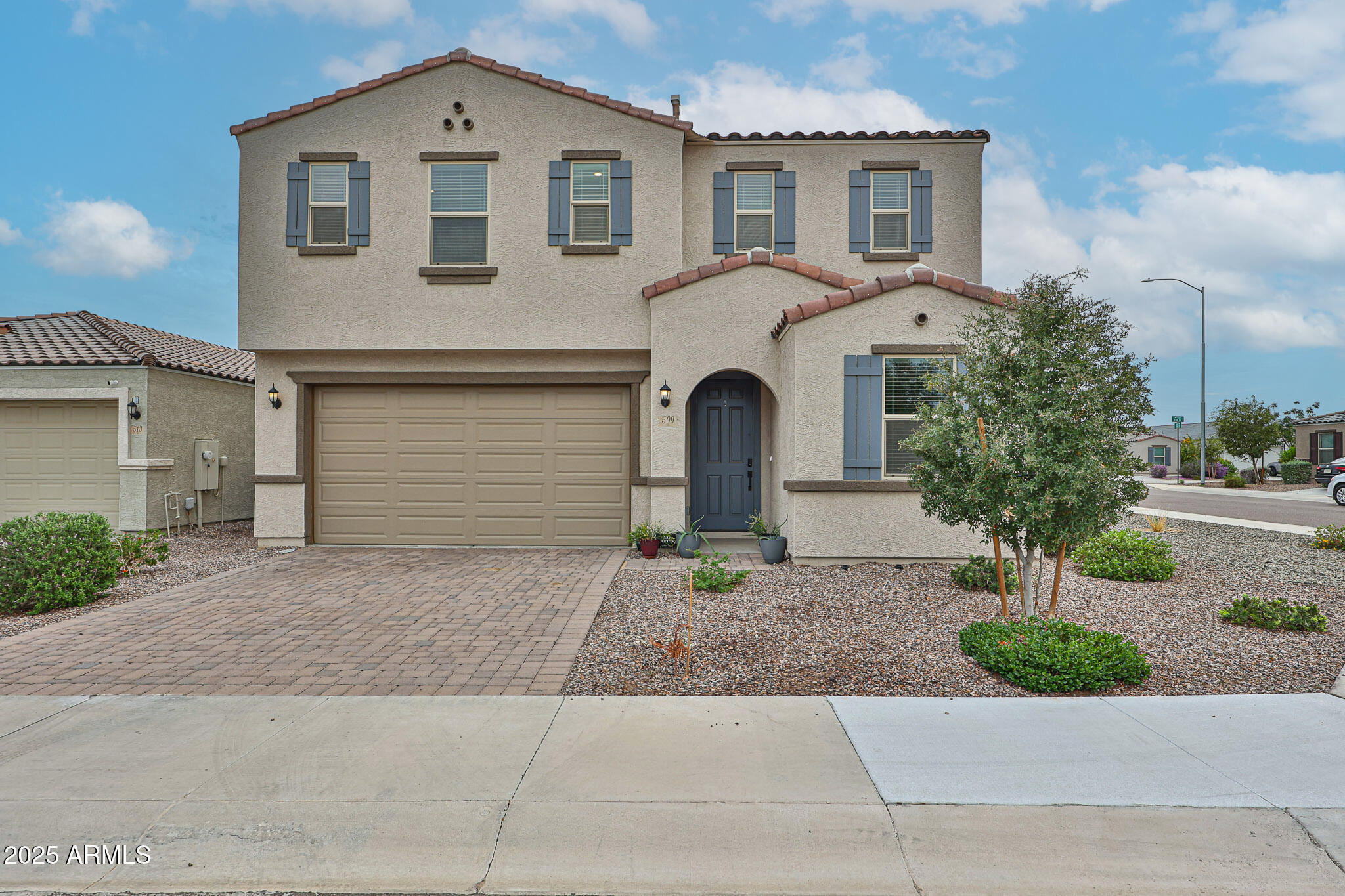 509 East Elm Lane Avondale, AZ 85323 - Photo 3 of 40 a front view of a house with a garden