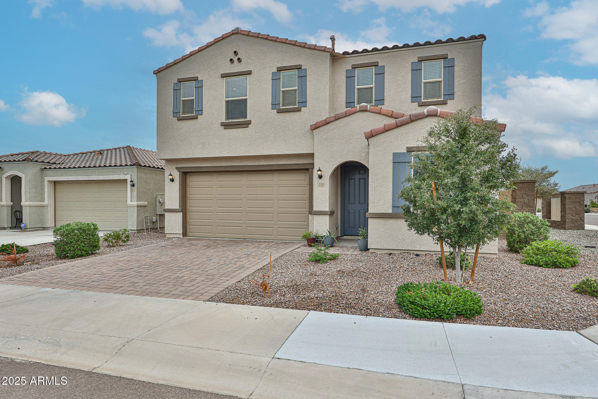 509 East Elm Lane Avondale, AZ 85323 - Photo 4 of 40 a front view of a house with garage and plants
