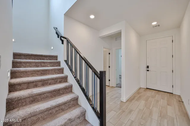 a view of a hallway with wooden floor and entryway