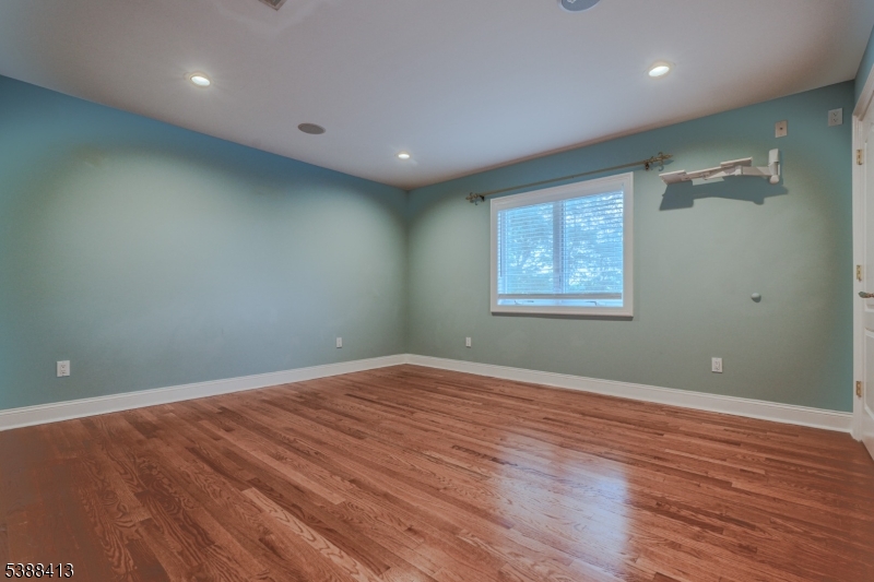 567 Mountain Avenue Springfield, NJ 07081 - Photo 16 of 28 an empty room with wooden floor and windows