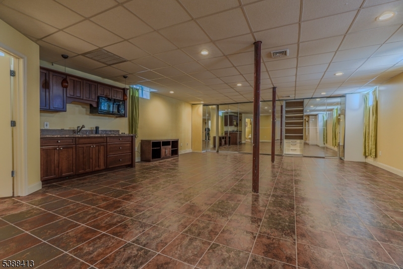 567 Mountain Avenue Springfield, NJ 07081 - Photo 22 of 28 a large parking space with wooden floor