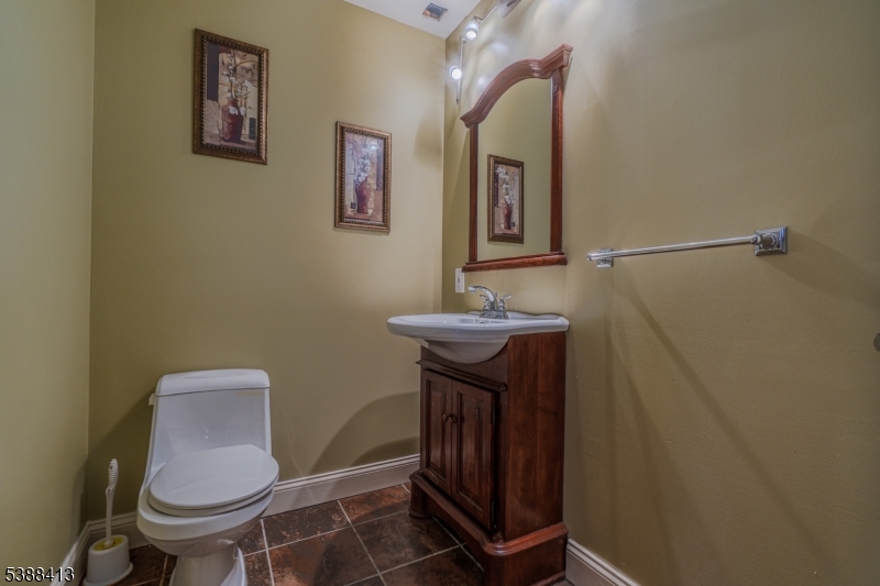 567 Mountain Avenue Springfield, NJ 07081 - Photo 24 of 28 a bathroom with a toilet a sink and mirror