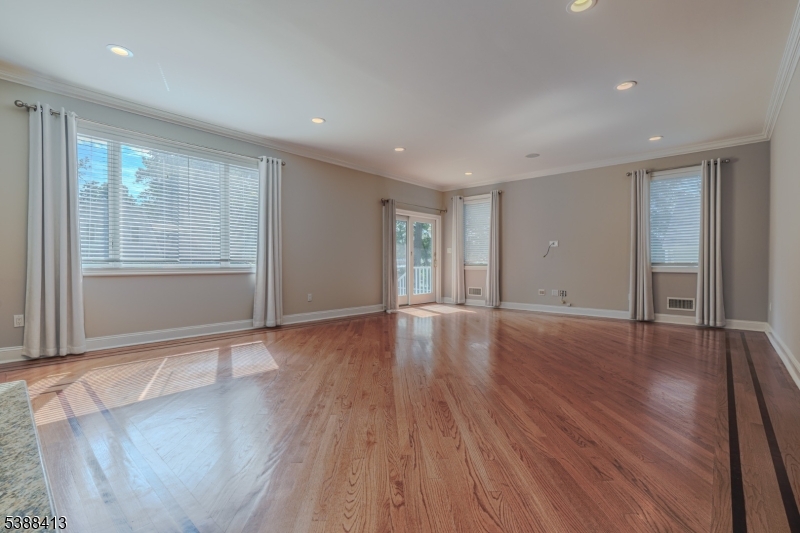 567 Mountain Avenue Springfield, NJ 07081 - Photo 6 of 28 a view of an empty room with wooden floor and a window