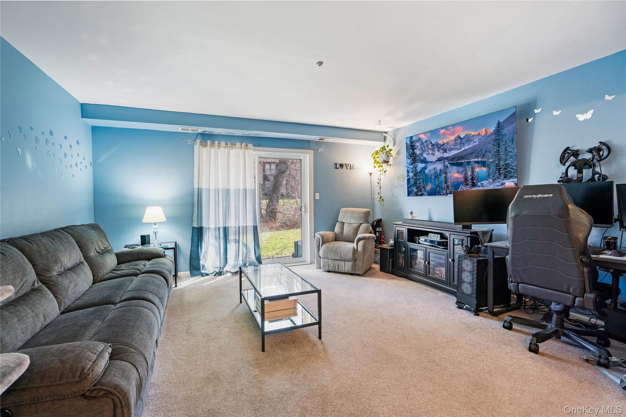 7 Maple Court, Unit 7 Selden, NY 11784 - Photo 11 of 18 a living room with furniture and a flat screen tv